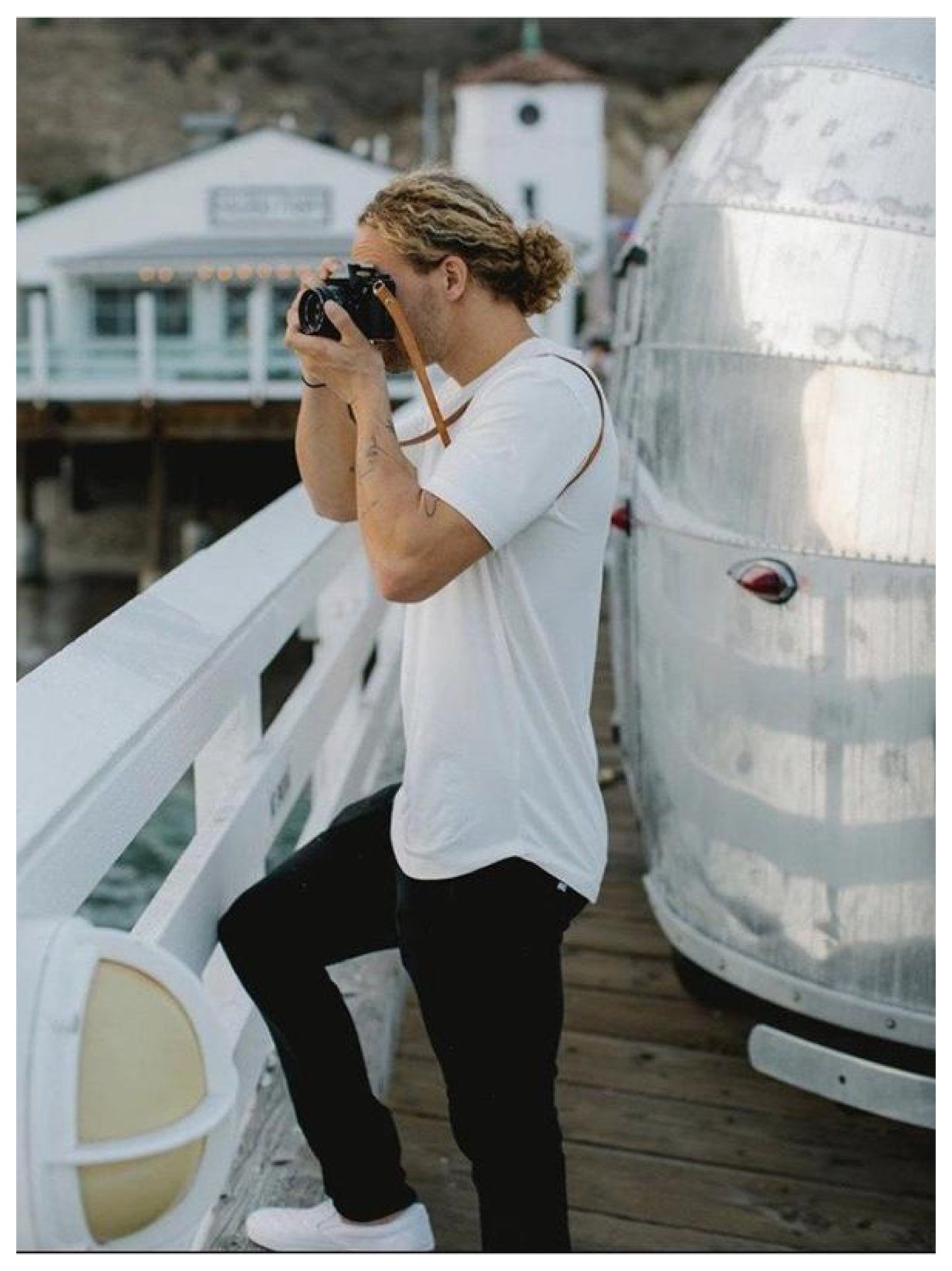 Photographer, using leather camera strap